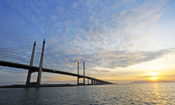 Wide angle view of the famous Penang bridge with the sunset as a backdrop.